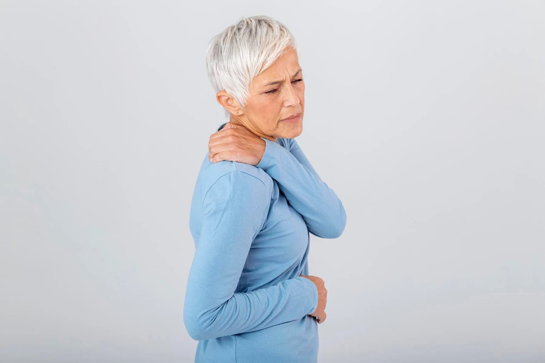 Woman holding her shoulder